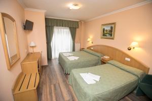 Postel nebo postele na pokoji v ubytování Hotel PAYRO