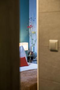 a bedroom with a bed and a vase with flowers at Décor Canal House in Amsterdam