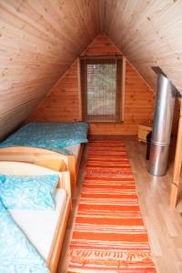 a room with two beds in a log cabin at Kimalase Metsamaja in Misso