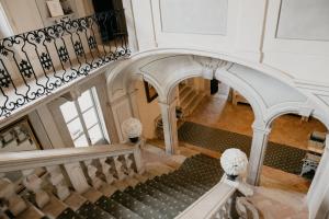 a large staircase leading up to a large room at Hotel Palazzo Novello in Montichiari