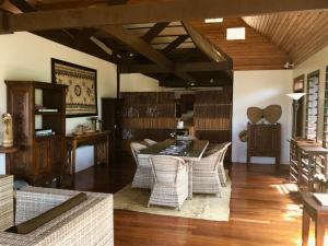 a dining room with a table and wicker chairs at Oneta Resort in Ono Island