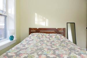 a bedroom with a bed with a floral blanket at The Greenleaf House in Chicago