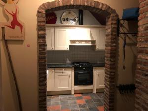 an archway into a kitchen with a stove top oven at landgoed Groot Boerle in Wijhe