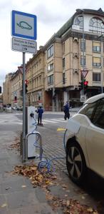 a car is hooked up to a charging station on a street at Domus Romanus in Ljubljana