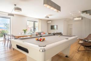 a living room with a pool table in it at Villa Olive Grove in Duće