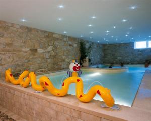 a large swimming pool with a inflatable at Hotel Bella Italia in Peschiera del Garda