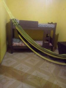 a hammock in the corner of a room at Santarém in Barreirinhas