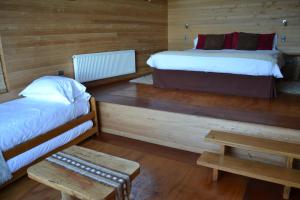 Voodi või voodid majutusasutuse Refugio Pullao toas