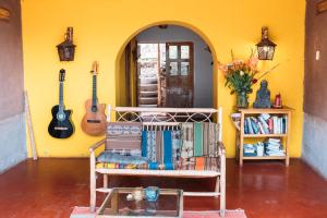 a room with a shelf of books and a guitar at La Chakana Pisac in Pisac