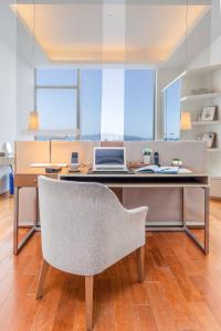 a desk with a laptop computer on top of it at The Connaught in Hong Kong