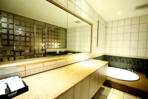 a bathroom with two sinks and a large mirror at Wen Mei Motel in Nantou City