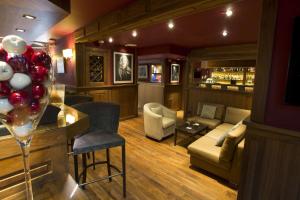 a living room with a bar with a wine glass at Best Western Plus Cannes Riviera & SPA in Cannes