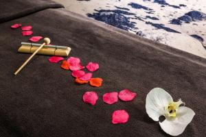 a group of flowers on a towel on the beach at Best Western Les Bains Hotel et SPA in Perros-Guirec