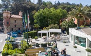 a group of people sitting outside of a building at Best Western Regina Elena in Santa Margherita Ligure