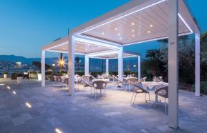 a restaurant with tables and chairs under a pavilion at Best Western Regina Elena in Santa Margherita Ligure