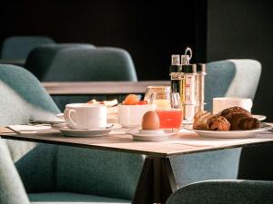 a table with a plate of food on it at Best Western Plus Antibes Riviera in Antibes +72 photos