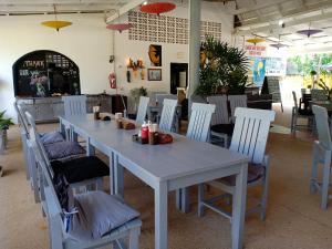 a white table and chairs in a restaurant at Diamond Sand Palace - SHA Plus in Ko Lanta