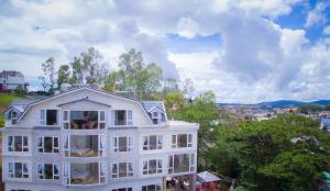 a large white building with a view of a city at Starview Villa Dalat in Da Lat
