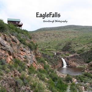 a waterfall on the side of a mountain at Eagle Falls Country Lodge & Adventures in Buffelsdrif