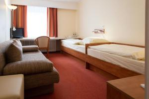 Säng eller sängar i ett rum på Hotel Daub