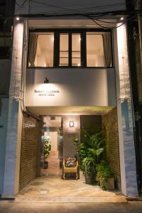 an entrance to a building with plants and a chair at Hotel Replace Namba Osaka in Osaka