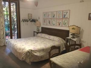 a bedroom with a bed and two chairs and a table at B&B La Castagnina in Bologna