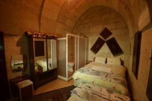 a bedroom with a bed in a stone room at Dar Konak Pansiyon in Urgup +38 photos