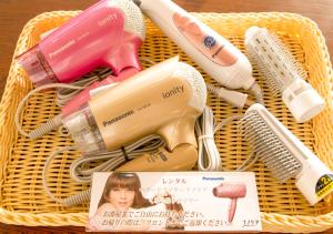 a basket with various hair brushes and a magazine at Hotel Airport Komatsu in Komatsu
