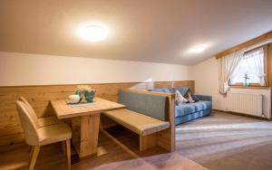 a living room with a table and a couch at Apart Heim in Fügen