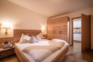 a bedroom with a large bed with a wooden headboard at Apart Heim in Fügen