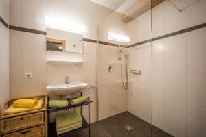 a white bathroom with a sink and a shower at Apart Heim in Fügen
