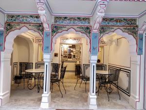 a dining room with a table and chairs at Jaipur Haveli in Jaipur