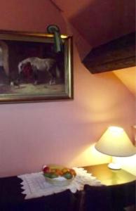 a table with a lamp and a bowl of fruit on it at Shirley Lane in Ashbourne