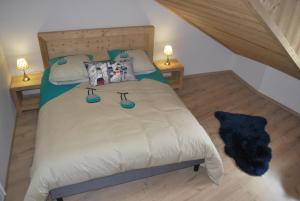 a bedroom with a large bed with two night stands at LE DOMAINE DU PATRE in Vaujany