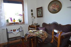 a living room with a table and a couch at Bebensee Edda DZ in Neustadt in Holstein
