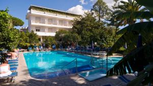 a large swimming pool in front of a hotel at Hotel Alpha in Sant'Agnello