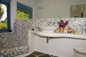 a bathroom with a sink and a mirror at Villa in Marathonos in Schinias