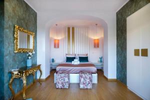 a bedroom with a bed and a table and a mirror at Casal Santa Virginia in Sintra