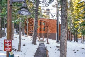 a house in the woods in the snow with a street light at Northstar - Ski Trail Condo in Kingswood Estates