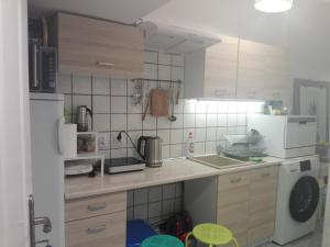 a kitchen with a white refrigerator and a sink at DobraNoc in Łódź