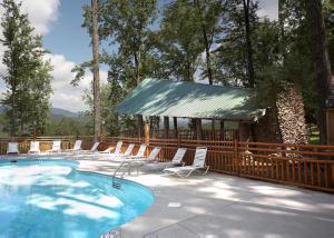 a swimming pool with chairs and a gazebo at Scenic Serenity #75 in Sevierville