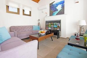 a living room with a couch and a table at Villa Marion in Ayia Napa