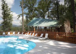 a swimming pool with chairs and a gazebo at Whispering Pines #33 in Sevierville
