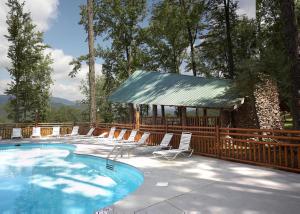 a swimming pool with chairs and a gazebo at Bear Hug #18 in Sevierville +11 photos
