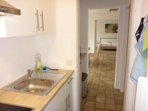 a kitchen with a sink and a dining room at Ferienwohnung Weyl in Eschbach +18 photos