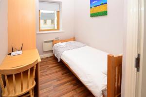 a small bedroom with a bed and a desk at Apartment 702 Letterfrack in Letterfrack