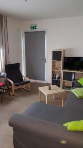 a living room with a couch and a table at Apartment am Apfelgarten in Schwarmstedt