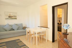 a living room with a table and a couch at Peaceful & Spacious Apt with Parking & Queen Bed in Carvoeiro