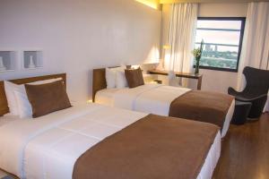 Esplendor by Wyndham Asuncion tesisinde bir odada yatak veya yataklar