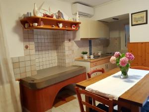 a kitchen with a table and a vase of flowers at Cres view apartments in Cres